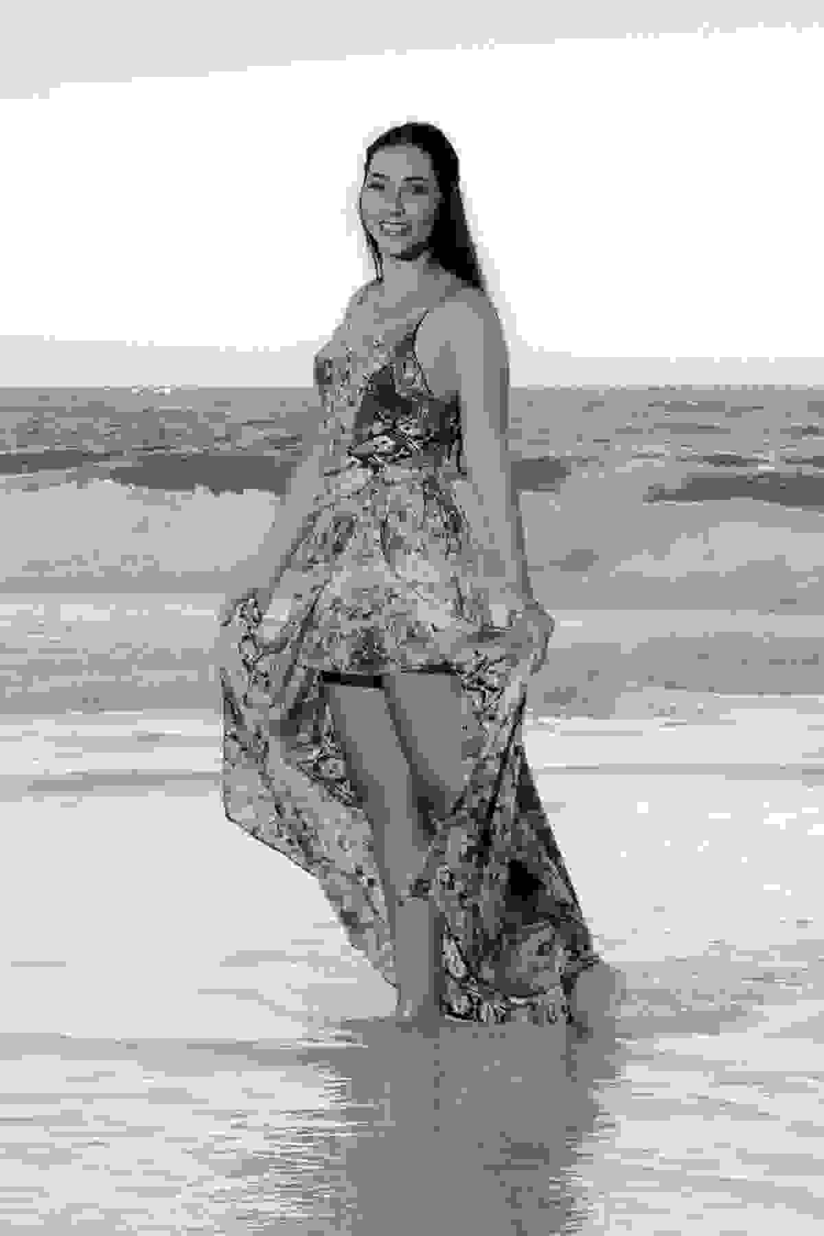 Fotografia da noiva em pose sozinha durante o ensaio de pré casamento de frente para o mar do atalaia em arraial do cabo